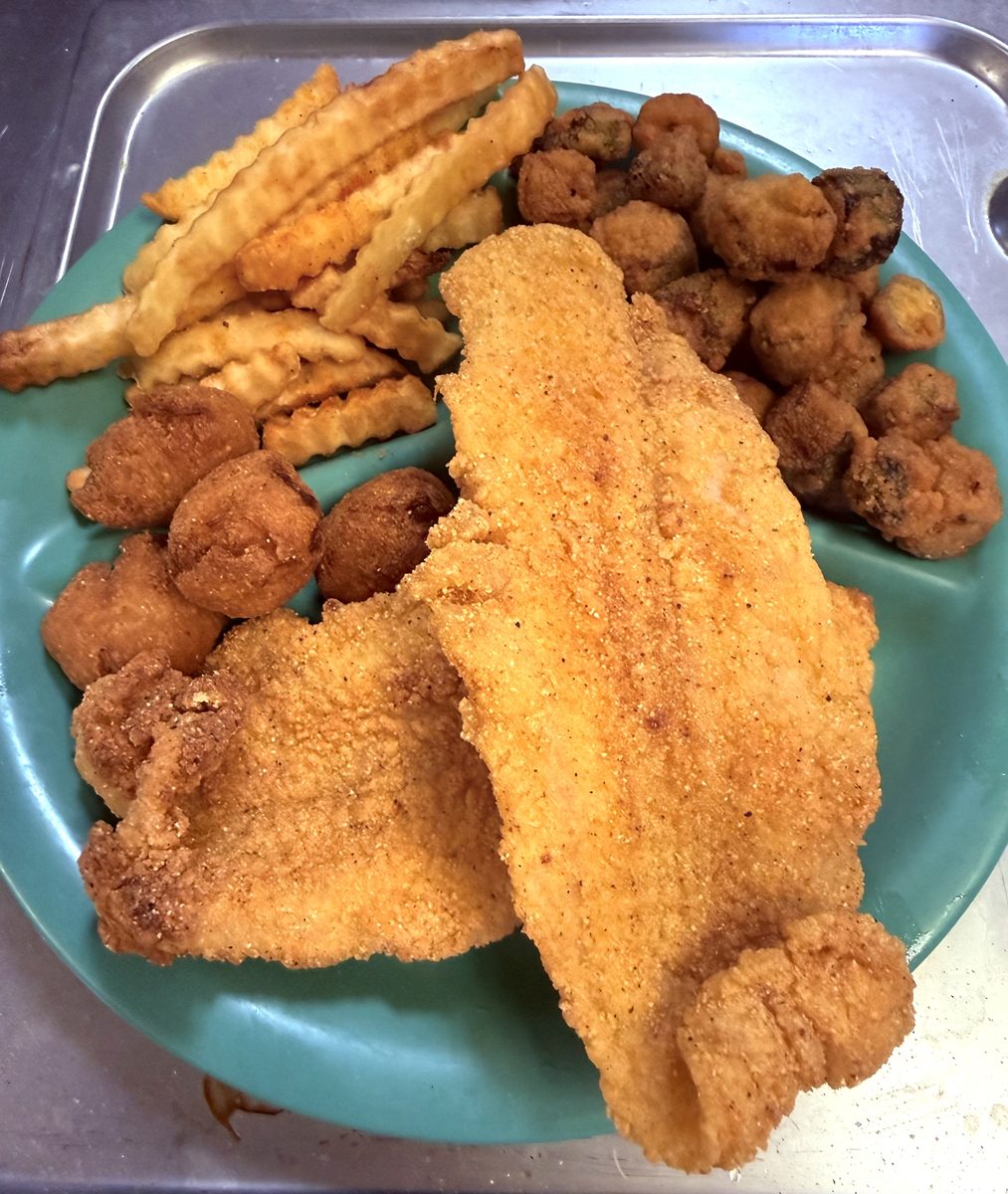 Two fried catfish filets with crinkle fries, fried okra and hushpuppies